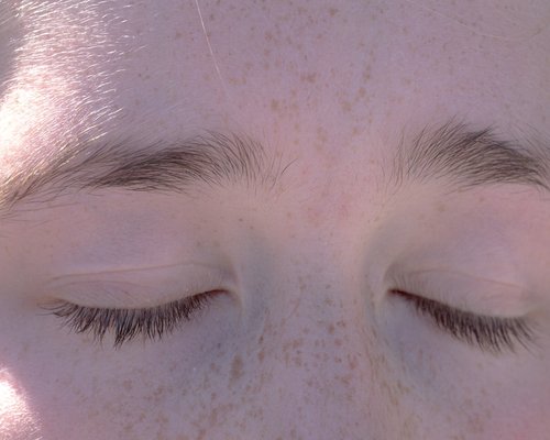 Person resting eyes by closing them gently